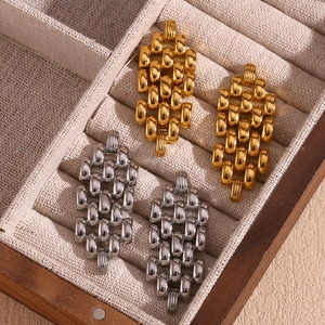 Watch band style chain earrings in gold and silver finish on a premium jewelry box