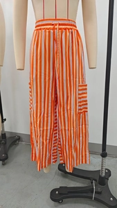 Detail of colorful vertical striped wide leg pants featuring adjustable drawstring elastic waist