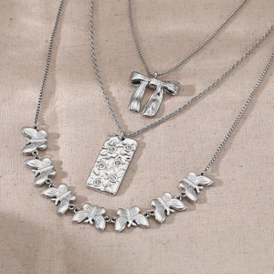 Three-layer stainless steel bow and butterfly pendant necklace in silver finish