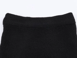 Detailed close-up of premium black rib-knit texture and thick woven fabric craftsmanship