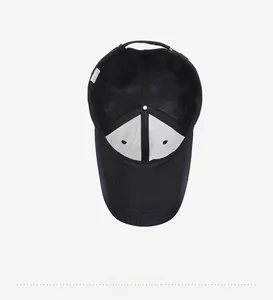 Close-up of black baseball cap interior with breathable mesh lining and washing label