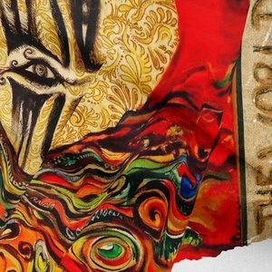 Close-up of bohemian tapestry fabric showing vibrant surrealist eye patterns and silky texture