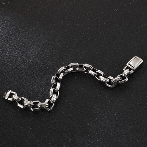 Detail of square link titanium steel bracelet with a vintage silver finish in industrial style
