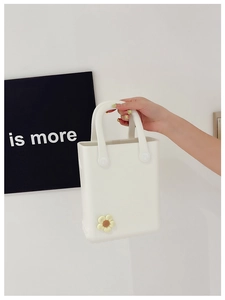 Detailaufnahme der weißen EVA-Strandtasche mit gelben Gänseblümchen-DIY-Accessoires