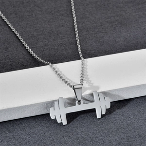 Detailed view of silver dumbbell pendant on O-chain necklace over a display stand