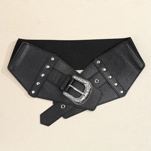 Detail of vintage black wide belt with silver floral buckle and decorative metal rivets