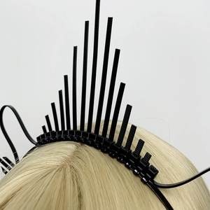 Macro shot of gothic black sunburst crown headband with spiked zip-tie halo texture