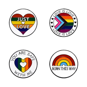 Rainbow enamel heart pins with Just Love and Born This Way slogans on white background