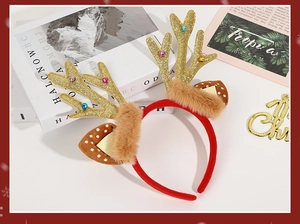 Detail of Christmas reindeer antler headband with glitter finish and mini jingle bells