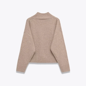 Back view of a minimalist oatmeal cashmere knit sweater with a cozy ribbed high neck collar