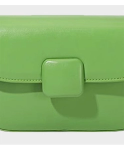 Detail of green PU leather crossbody bag featuring a puffy texture and square buckle