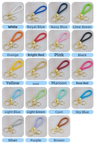 Detail view of colorful braided leather keychains with gold metal lobster clasps