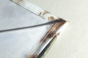 Close-up of overlock stitching and camouflage print on soft knitted dress fabric