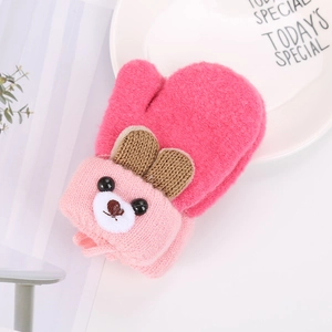 Detail of pink knitted baby mitten featuring a cute brown-eared bear cartoon design
