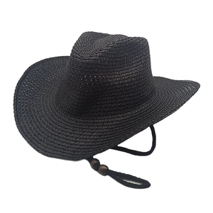 Detail of black woven cowboy hat showing texture and adjustable cord with wooden beads