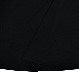 Detailed close-up showing the premium black fabric texture and neat stitching of the dress