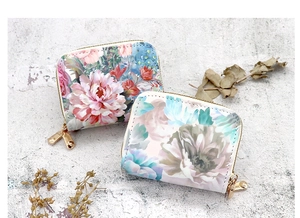 Close-up detail of floral print dual zipper card holder wallets with flower patterns