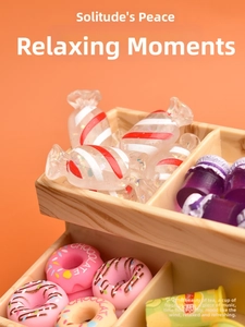 Miniature Christmas candy and donuts with chocolate frosting in a wooden display rack