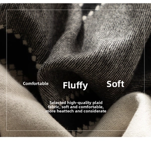 Macro shot of thick color-block knit scarf showing premium soft texture and warm fabric
