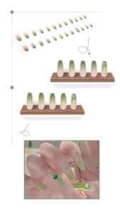 Detail of coffin-shaped press-on nails with pink-green gradient and heart rhinestones