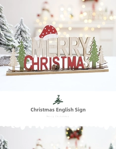 Close-up of wooden Merry Christmas sign with pine cones and snow-covered trees