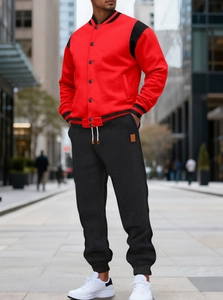 Detail of red varsity jacket with black sleeves and matching jogger pants set