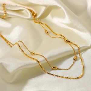 Elegant 18K gold-plated double-layer stainless steel necklace with bead accents on silk