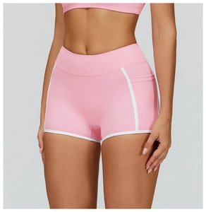 Detailed view of pink yoga shorts with high waist, white contrast trim and side pocket