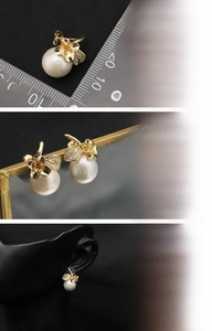 Detail showing 18K gold plated flower earrings with freshwater pearls and zircons