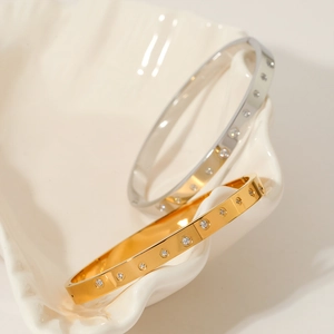 Elegant gold and silver stainless steel bangles with cubic zirconia stones and mirror finish