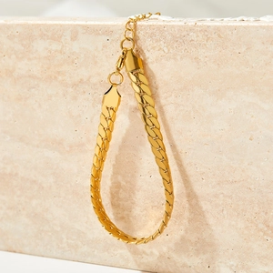 6.5mm gold plated stainless steel Cuban link necklace displayed on a beige stone slab