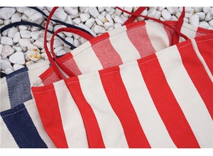 Detailed close-up of thick striped canvas material and textured weave on shoulder bags