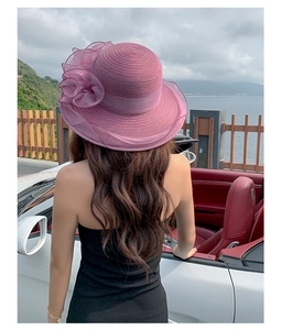 Detailed view of purple organza flower on a wide brim sun hat for summer beach wear