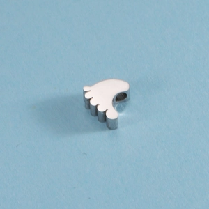 Macro shot of mirror-polished stainless steel baby footprint charm for DIY jewelry