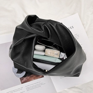 Minimalist black lychee pattern cloud bag showing spacious interior with daily essentials