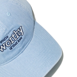 Detailed close-up of premium 3D embroidery on washed cotton baseball cap texture