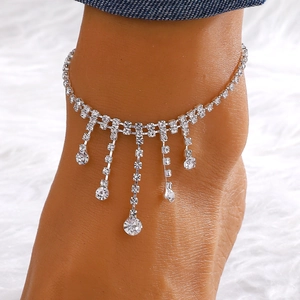 Close-up of silver tassel anklet with sparkling rhinestone water drop charms on feet