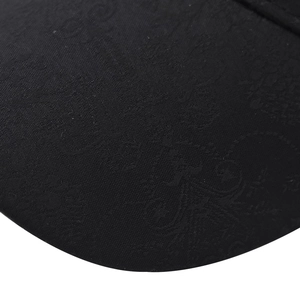 Close-up of black cotton baseball cap showing luxury jacquard floral pattern textures