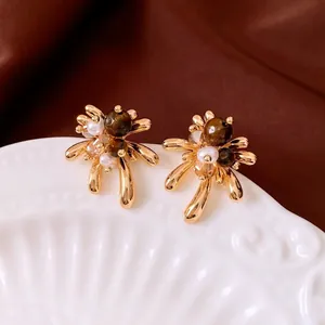 Retro 18K gold plated tiger eye stone stud earrings with pearls on white ceramic tray