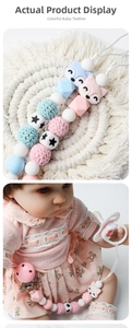 Detail of fox-shaped pacifier clip with handmade crochet beads and silicone star charms
