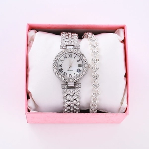 Macro shot of silver crystal watch and heart bracelet set in a pink gift box