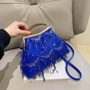 Detail of blue sequined evening bag with fringe tassels and gold trapezoid handle