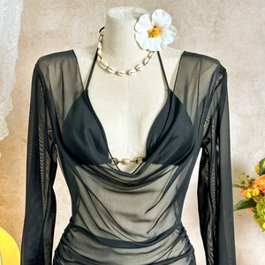 Detail of sheer black mesh top with draped neckline and metal ring bikini detail