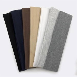 Selection of seven colored cotton sports headbands displayed in a clean fan arrangement