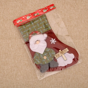 Detail of linen Christmas stocking with 3D Santa doll and Merry Christmas wood plaque