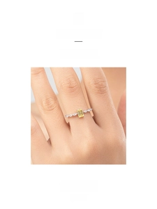 Detail of S925 silver ring with emerald-cut yellow stone and marquise diamond accents
