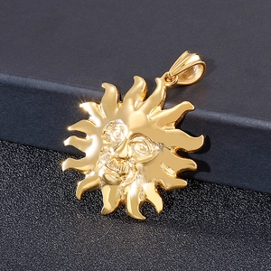 Detailed close-up of golden sun god pendant in polished titanium steel on textured background