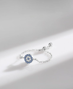 Detailed macro view of S925 silver evil eye ring with blue cubic zirconia micro-pave setting