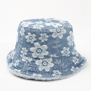 Light blue denim bucket hat with white daisy embroidery and trendy frayed edges