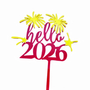 Detail of hello 2026 acrylic cake topper with pink lettering and yellow fireworks
